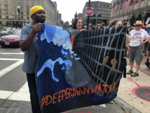 No More Cages demonstrators hold banner that says #DeeperThanWater
